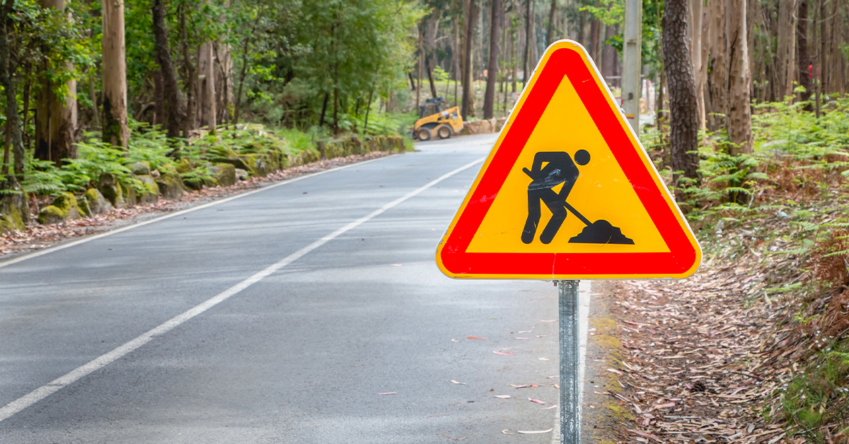 Red and yellow triangle construction sign signaling roadwork ahead 