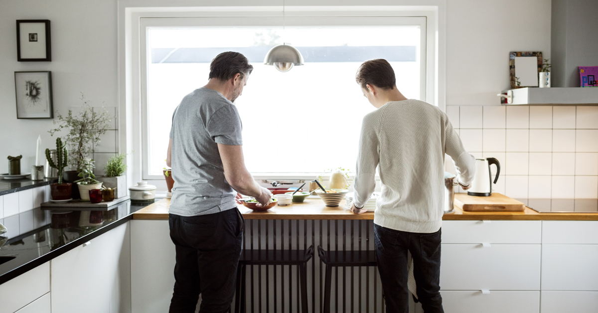 Father and adult son in kitchen