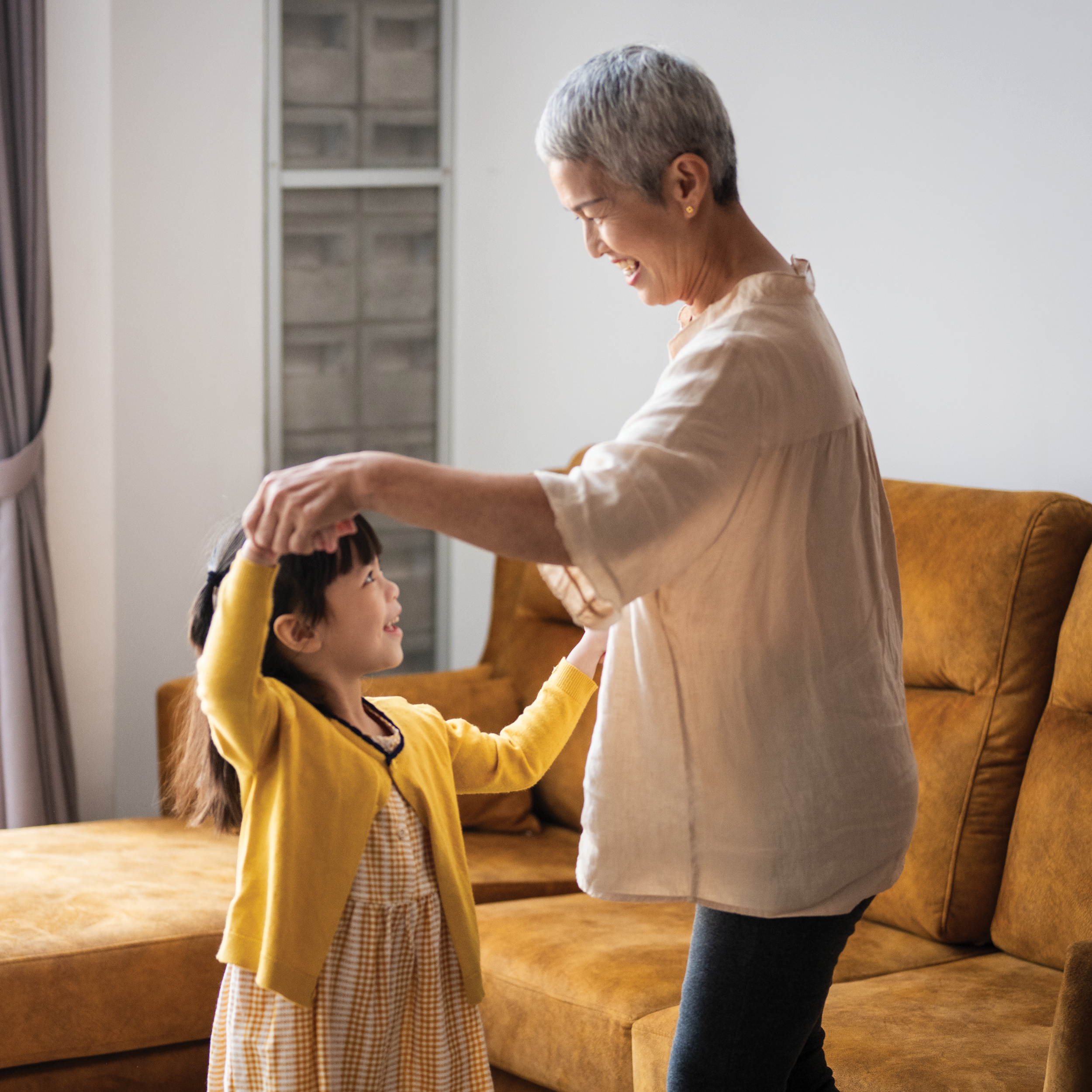 Older woman and girl dancing