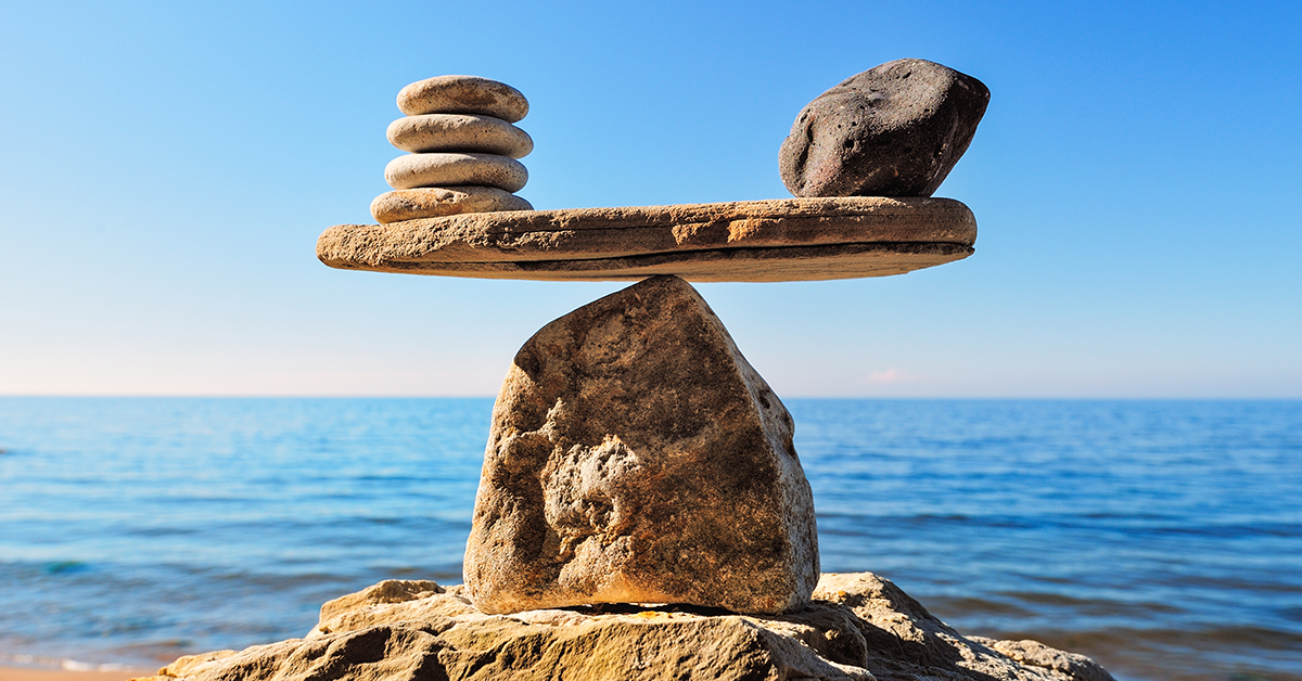 A tower of rocks balancing by the shoreline.